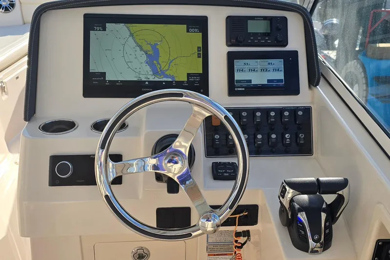  Yacht Photos Pics 2022 Grady-White Freedom 285 boat dashboard with navigation and control systems.