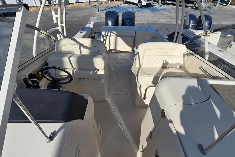  Yacht Photos Pics 2022 Grady-White Freedom 285 boat interior with seating and steering wheel.
