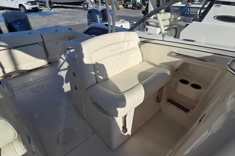  Yacht Photos Pics 2022 Grady-White Freedom 285 boat interior with cushioned seating and cup holders.