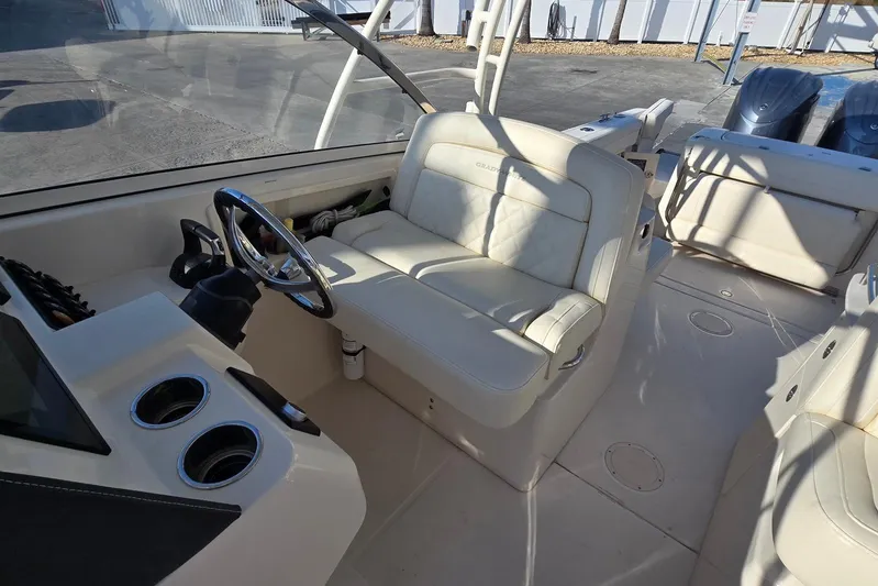  Yacht Photos Pics 2022 Grady-White Freedom 285 boat interior with steering wheel and seating.