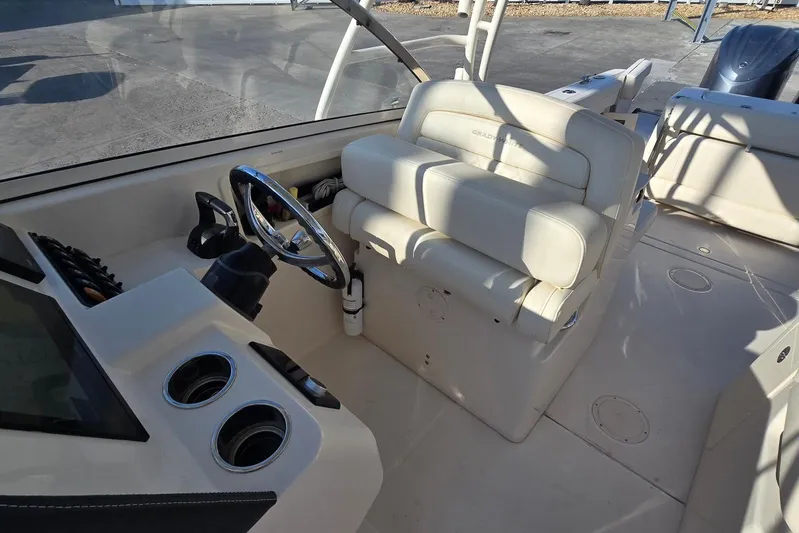  Yacht Photos Pics 2022 Grady-White Freedom 285 boat interior with steering wheel and seating.