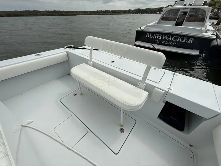  Yacht Photos Pics 2003 Strike 35 Cuddy boat with white seating, docked near another vessel.