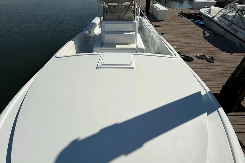  Yacht Photos Pics 2003 Strike 35 Cuddy boat docked, showcasing spacious deck and seating area.