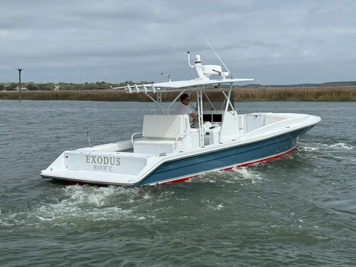  Yacht Photos Pics 2003 Strike 35 Cuddy boat cruising on water, featuring sleek design and white hull.