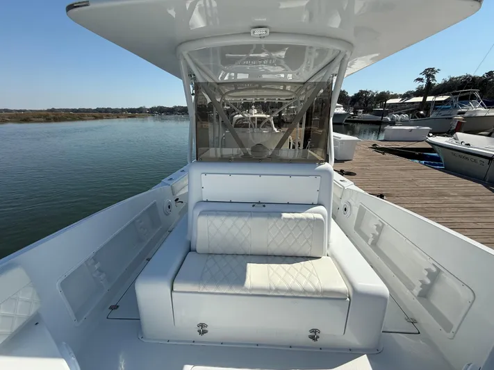  Yacht Photos Pics 2003 Strike 35 Cuddy boat with white seating, docked by the water.