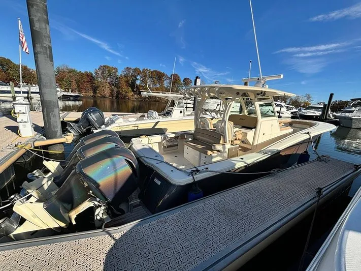  Yacht Photos Pics 2016 Scout 350 LXF boat docked at marina with triple outboard engines.