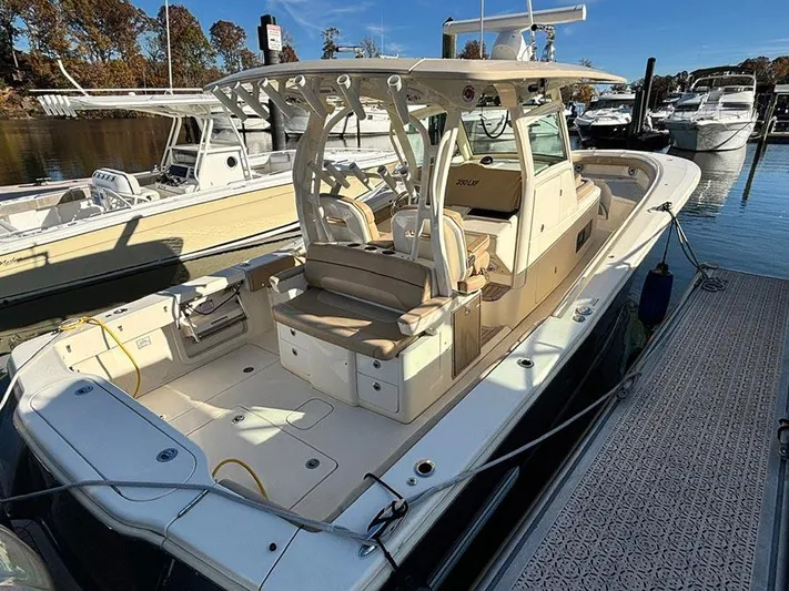  Yacht Photos Pics 2016 Scout 350 LXF boat docked at marina, featuring spacious seating and modern design.