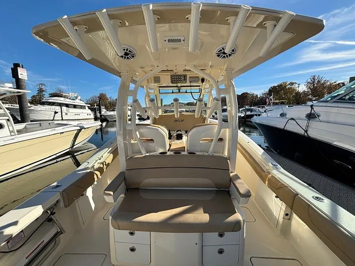  Yacht Photos Pics 2016 Scout 350 LXF boat interior at marina, featuring seating and rod holders.