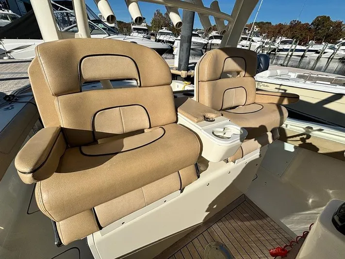  Yacht Photos Pics 2016 Scout 350 LXF boat interior with beige cushioned seats and cup holders.
