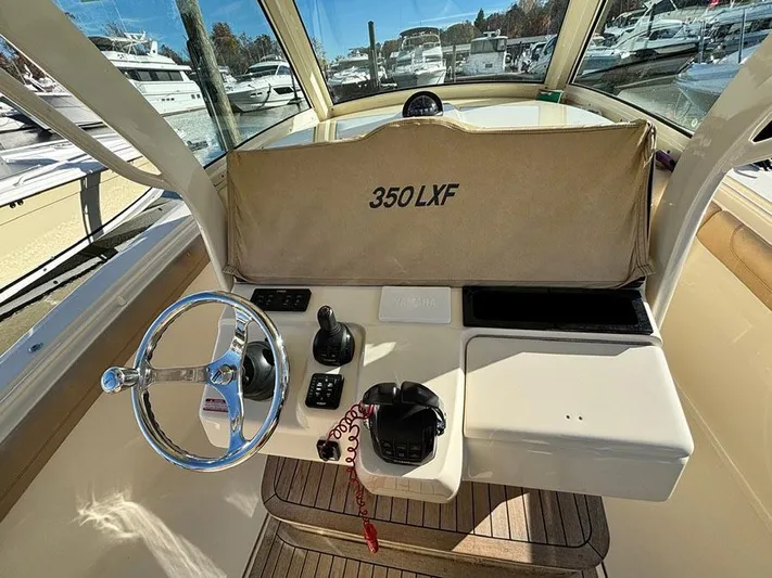  Yacht Photos Pics 2016 Scout 350 LXF boat helm with steering wheel and controls.