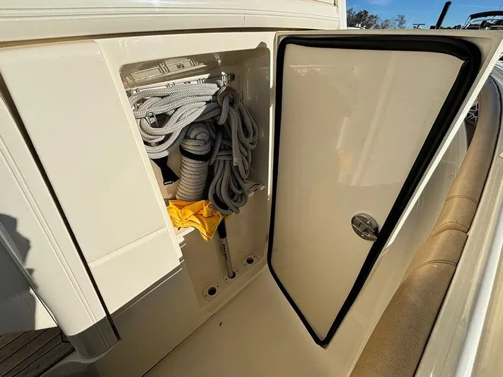  Yacht Photos Pics Open storage compartment on 2016 Scout 350 LXF boat with ropes and equipment.