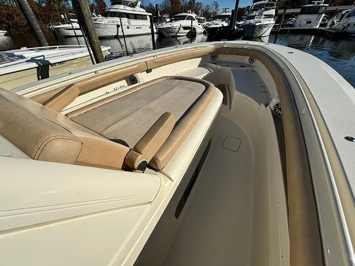  Yacht Photos Pics 2016 Scout 350 LXF boat interior with tan seating, docked in a marina.