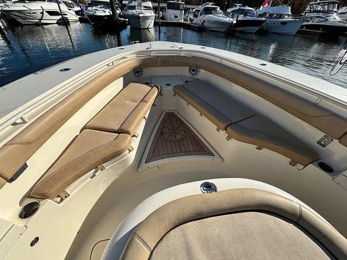  Yacht Photos Pics 2016 Scout 350 LXF boat interior with cushioned seating, docked at marina.