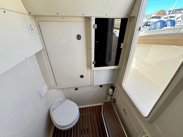  Yacht Photos Pics 2016 Scout 350 LXF boat interior with toilet and storage cabinet.