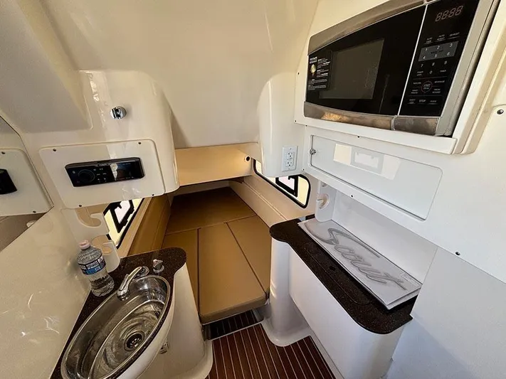  Yacht Photos Pics 2016 Scout 350 LXF cabin interior with sink, microwave, and sleeping area.