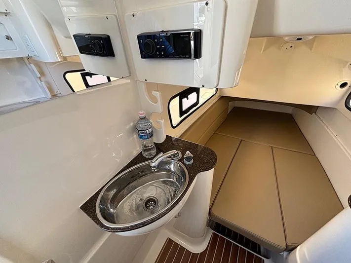  Yacht Photos Pics 2016 Scout 350 LXF cabin interior with sink, bed, and storage compartments.