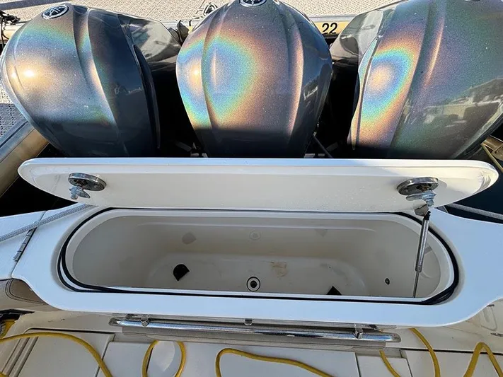  Yacht Photos Pics 2016 Scout 350 LXF boat with open storage compartment and triple outboard engines.