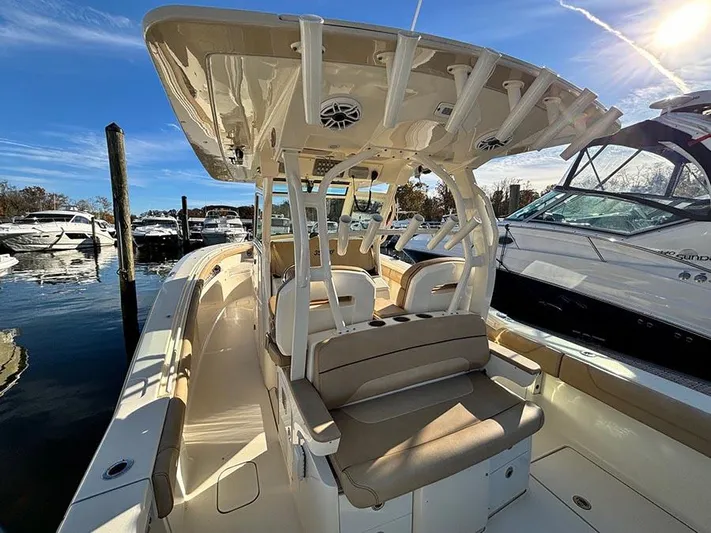  Yacht Photos Pics 2016 Scout 350 LXF boat docked, featuring spacious seating and sleek design.