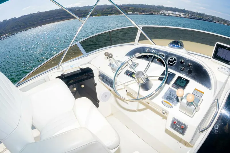 Adventures Await Yacht Photos Pics Pilothouse of 2004 Meridian 490 yacht with steering wheel and control panel.