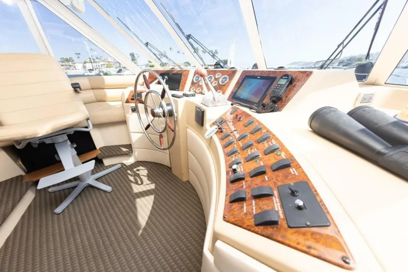 Adventures Await Yacht Photos Pics 2004 Meridian 490 Pilothouse interior with steering wheel and control panel.