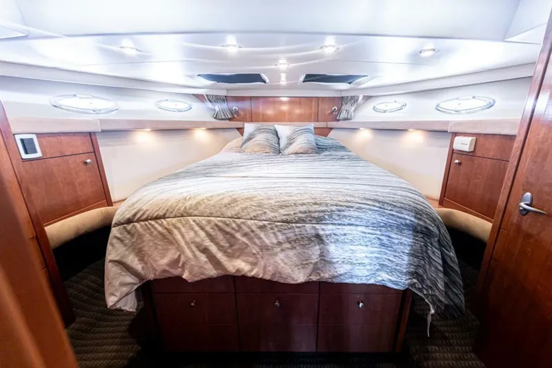 Adventures Await Yacht Photos Pics Luxurious bedroom interior of 2004 Meridian 490 Pilothouse yacht with elegant wood finish.