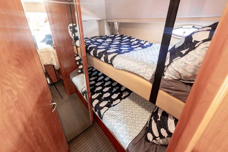 Adventures Await Yacht Photos Pics Bunk beds in 2004 Meridian 490 Pilothouse cabin with nautical-themed bedding.