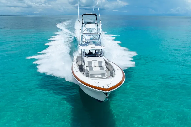  Yacht Photos Pics 2023 Front Runner 47 Center Console boat cruising on clear turquoise water.