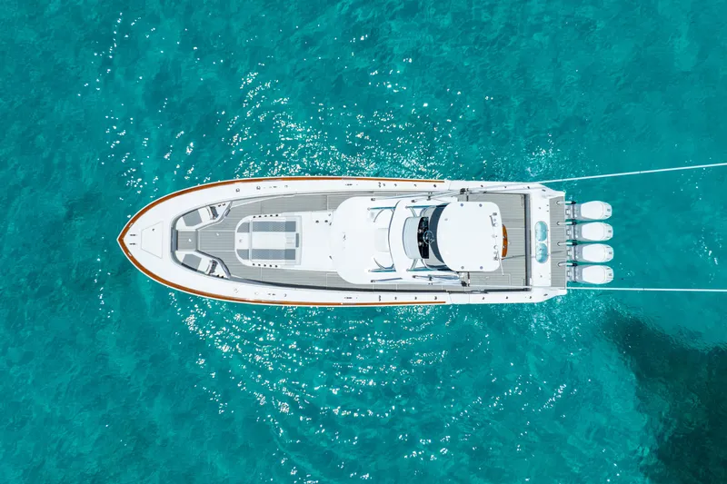  Yacht Photos Pics Aerial view of 2023 Front Runner 47 Center Console boat on clear blue water.