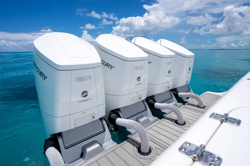  Yacht Photos Pics Four Mercury outboard engines on a 2023 Front Runner 47 Center Console boat in clear blue water.