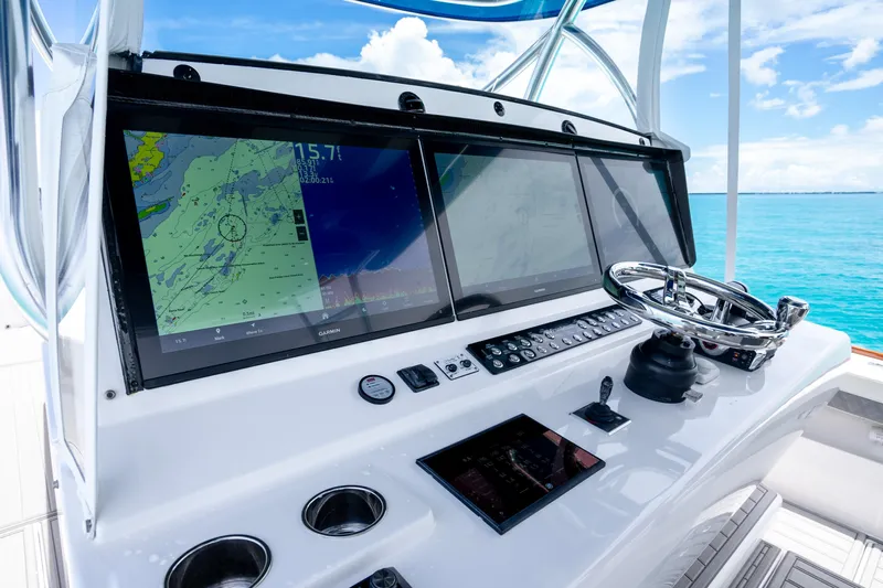  Yacht Photos Pics 2023 Front Runner 47 Center Console boat dashboard with navigation screens and steering wheel.
