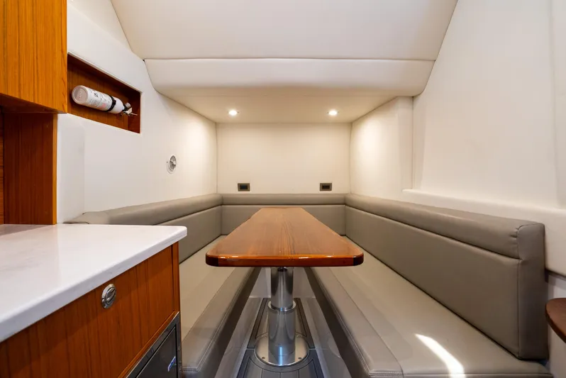  Yacht Photos Pics 2023 Front Runner 47 Center Console interior with sleek seating and wooden table.