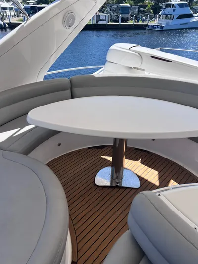 Susi Yacht Photos Pics Azimut 55 Flybridge 2005 yacht interior with round table and cushioned seating.