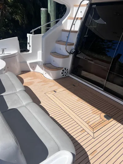 Susi Yacht Photos Pics Azimut 55 Flybridge 2005 yacht deck with seating and stairs, featuring sleek design and wood finish.