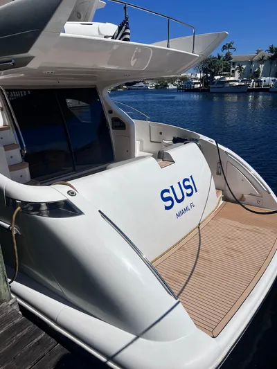 Susi Yacht Photos Pics 2005 Azimut 55 Flybridge yacht docked, featuring spacious deck and sleek design.