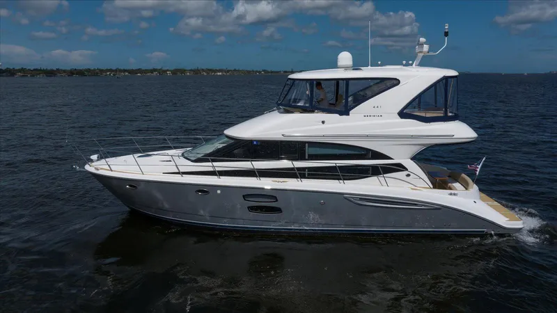 Gail’s Storm IV Yacht Photos Pics 2015 Meridian 441 Sedan yacht cruising on open water under a clear sky.