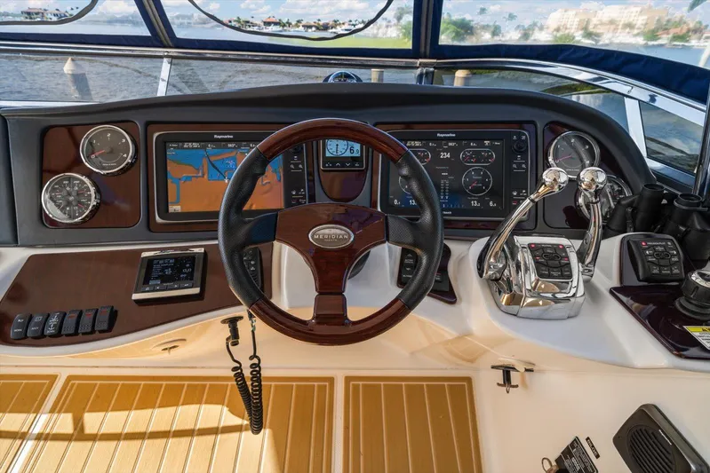 Gail’s Storm IV Yacht Photos Pics Cockpit of 2015 Meridian 441 Sedan yacht with navigation screens and controls.