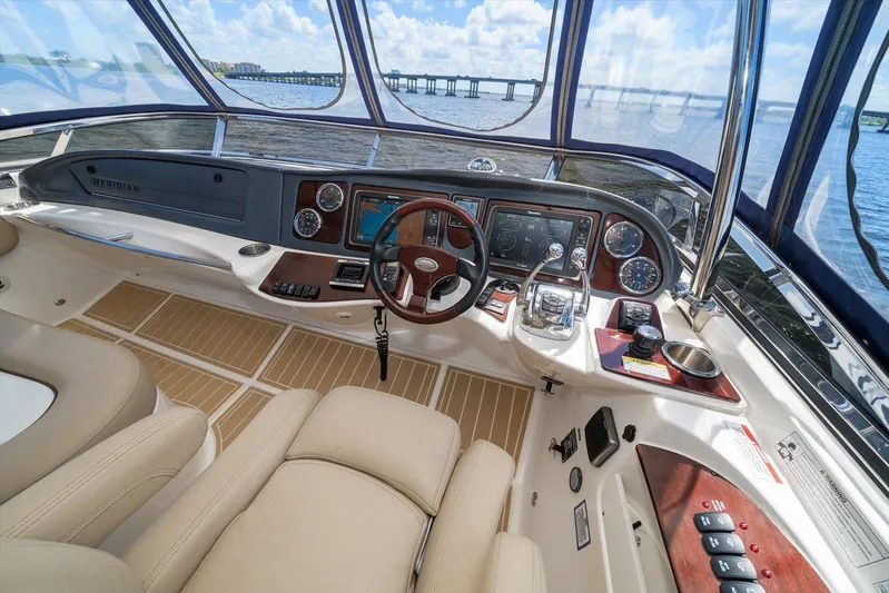 Gail’s Storm IV Yacht Photos Pics 2015 Meridian 441 Sedan yacht helm with luxurious controls and panoramic water view.