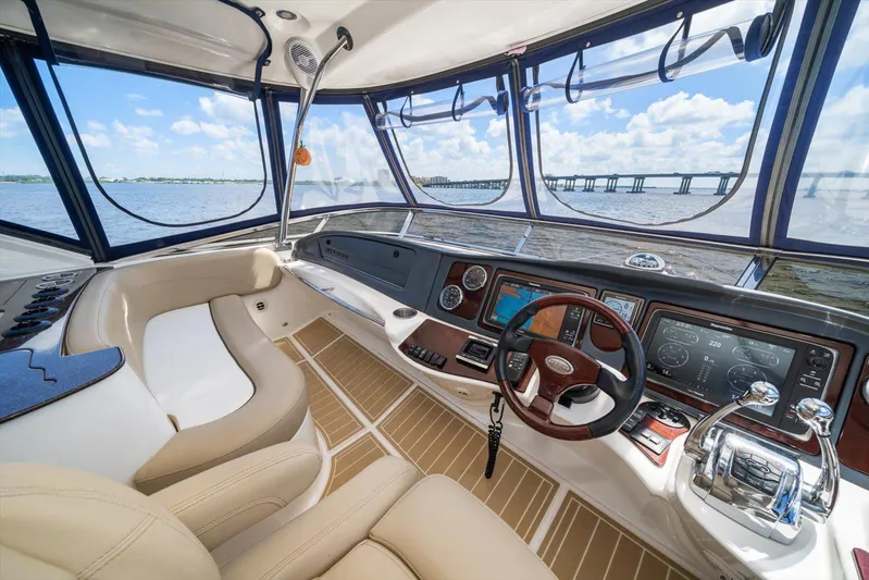 Gail’s Storm IV Yacht Photos Pics Luxurious 2015 Meridian 441 Sedan yacht interior with modern navigation controls and panoramic water views.