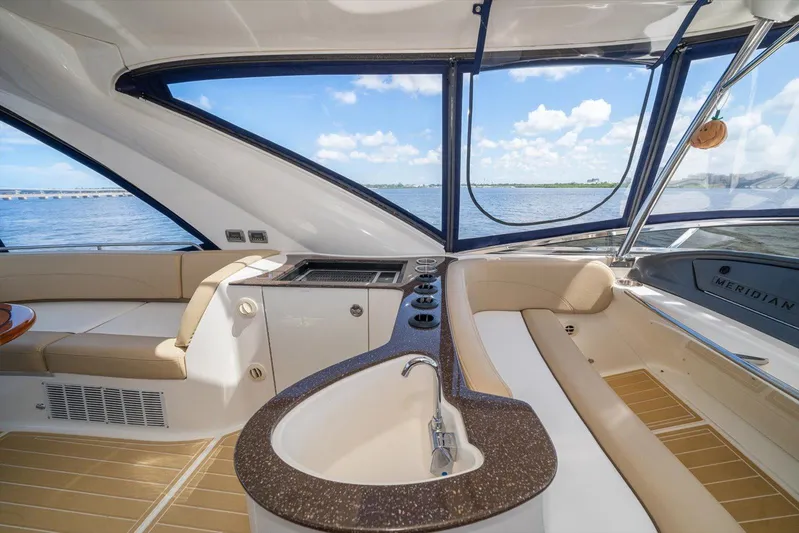 Gail’s Storm IV Yacht Photos Pics Luxurious interior of 2015 Meridian 441 Sedan yacht with panoramic windows and elegant seating.