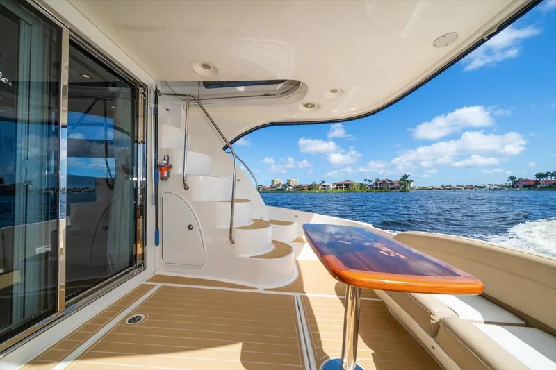 Gail’s Storm IV Yacht Photos Pics Luxurious 2015 Meridian 441 Sedan yacht deck with ocean view and elegant seating area.