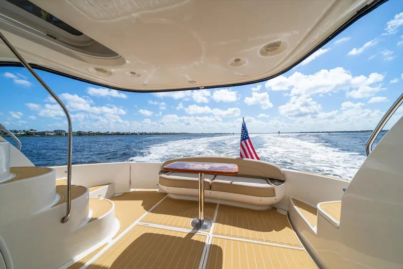Gail’s Storm IV Yacht Photos Pics Luxurious 2015 Meridian 441 Sedan yacht interior with ocean view and American flag.