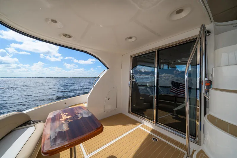 Gail’s Storm IV Yacht Photos Pics 2015 Meridian 441 Sedan yacht deck with ocean view and American flag.