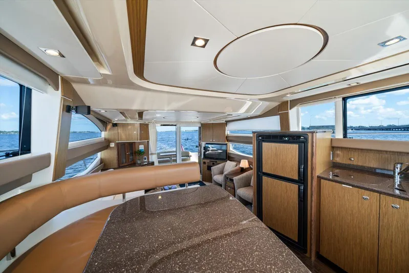 Gail’s Storm IV Yacht Photos Pics Luxurious interior of 2015 Meridian 441 Sedan yacht with modern furnishings and ocean view.