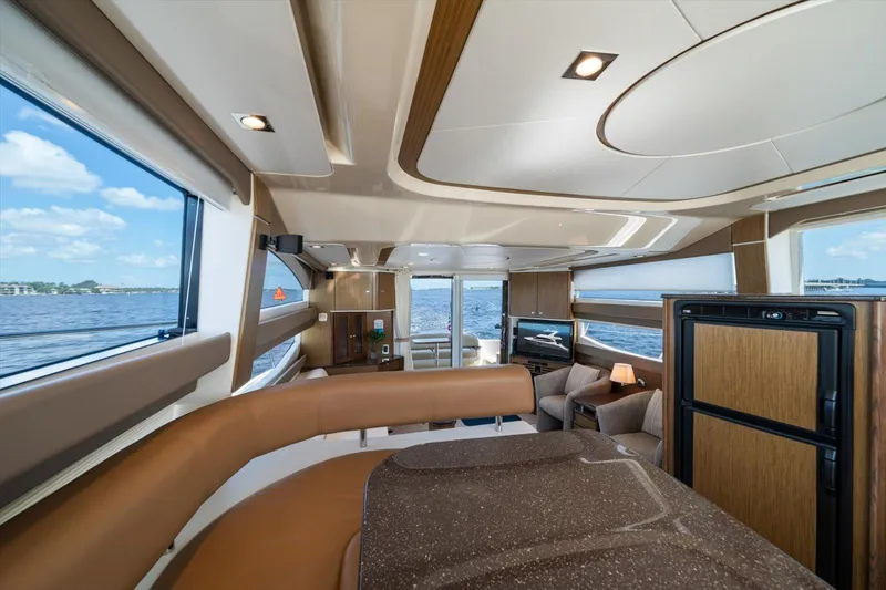 Gail’s Storm IV Yacht Photos Pics Luxurious interior of 2015 Meridian 441 Sedan yacht with panoramic windows and modern furnishings.