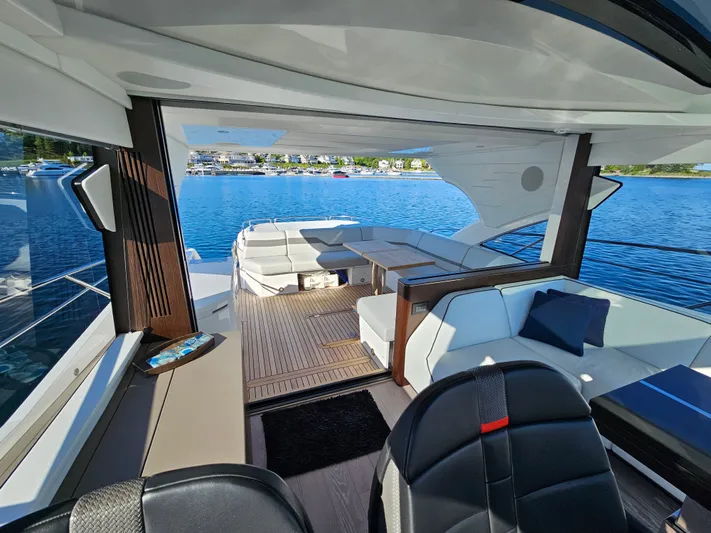 Tango Lima Yacht Photos Pics Luxurious interior of 2022 Sunseeker 60 Predator EVO yacht with elegant seating and scenic water view.