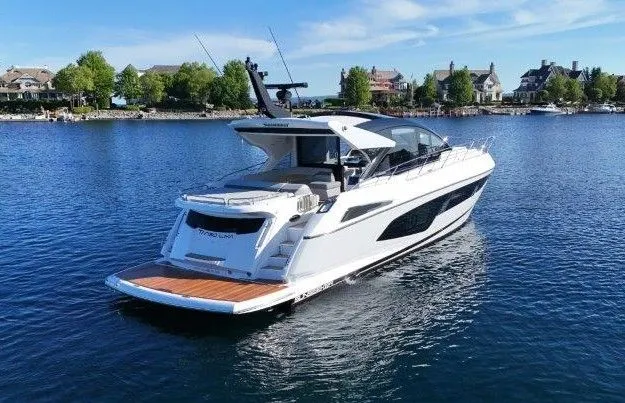 Tango Lima Yacht Photos Pics 2022 Sunseeker 60 Predator EVO yacht on serene water with scenic background.
