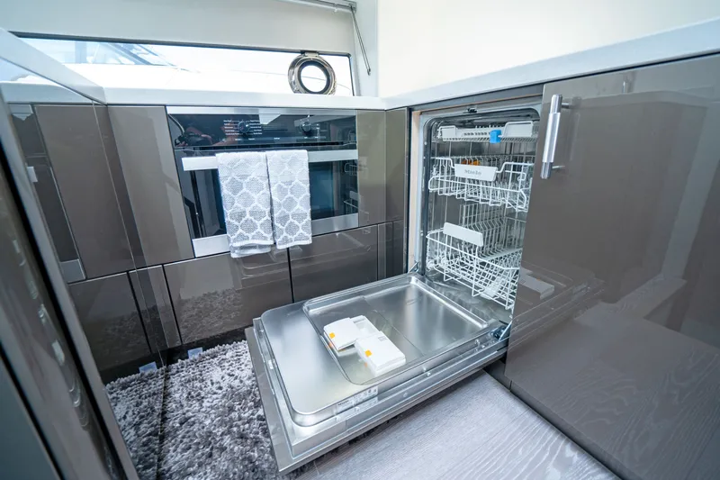 Tango Lima Yacht Photos Pics Modern kitchen with open dishwasher on Sunseeker 60 Predator EVO yacht, 2022 model.