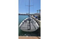 Custom TP 52 sailboat, 2007 model, docked in a sunny marina.