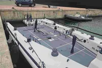 Sailboat docked in marina, TP 52 model, 2007, with inflatable boat nearby.