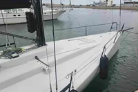 Sleek white TP 52 sailboat docked in a marina, 2007 model.